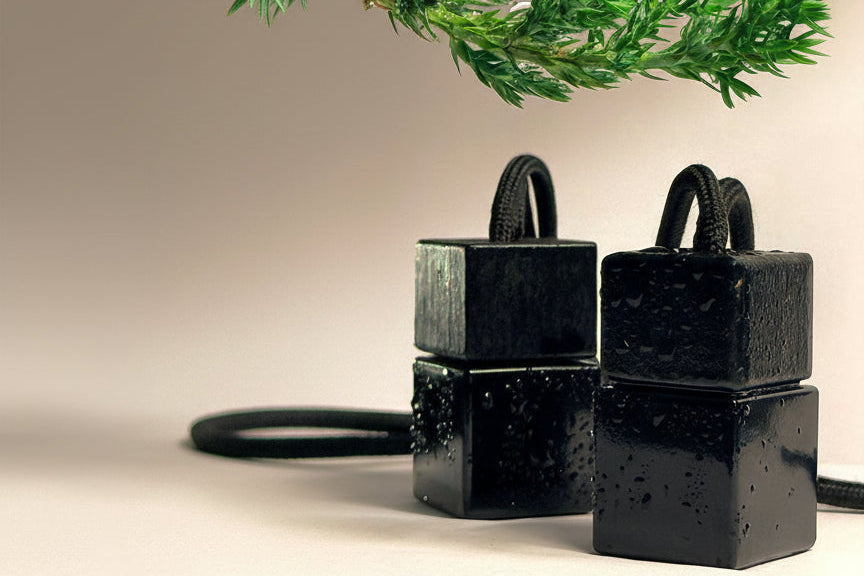 Black square containers with handles on a light background